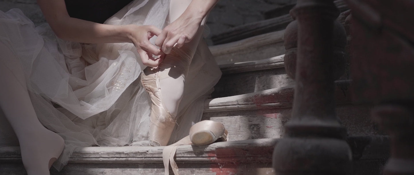 Close-up video of ballerina tying her pointe shoe ribbons — ballet aesthetic clip featuring custom ribbon gift concept.